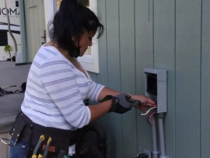 Licensed electrician wiring an exterior subpanel in Seven Corners
